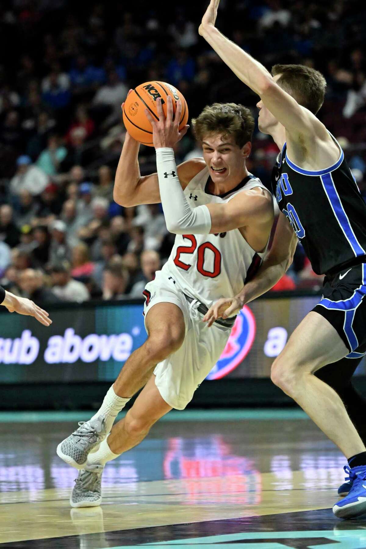 Saint Mary's guard Aidan Mahaney (20) drives the ball against BYU during the first half of an NCAA college basketball game in the semifinals of the West Coast Conference men's tournament Monday, March 6, 2023, in Las Vegas. (AP Photo/David Becker)