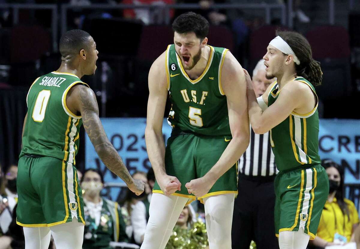 Khalil Shabazz (0), Saba Gigiberia (5) and Tyrell Roberts (1) of the USF Dons react after Gigiberia drew an offensive foul call against the Gonzaga Bulldogs in the first half of a semifinal game of the West Coast Conference basketball tournament on Monday.