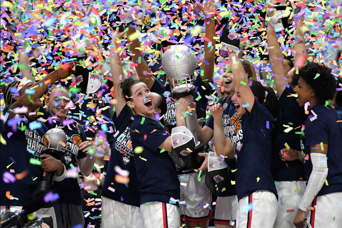 UConn's Lou Lopez Senechal smiles as she holds the Big East Championship trophy while celebrating with teammates after a win against Villanova in an NCAA college basketball game in the finals of the Big East Conference tournament at Mohegan Sun Arena, Monday, March 6, 2023, in Uncasville, Conn. (AP Photo/Jessica Hill)
