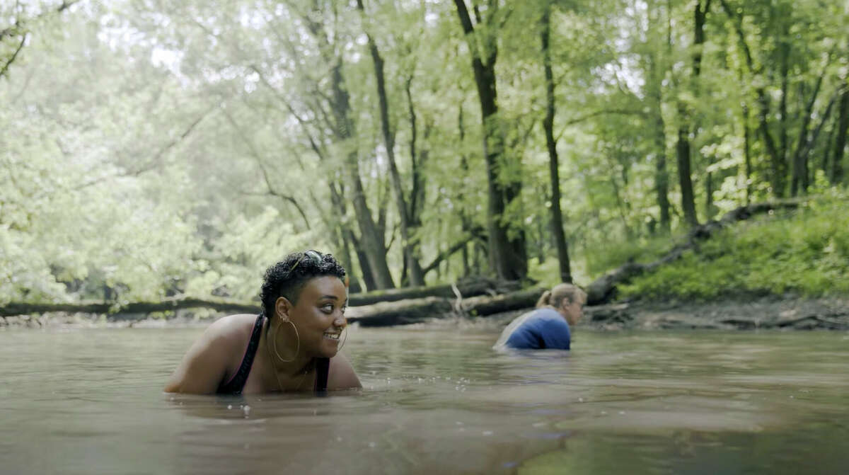 RiverWatch Volunteer Nina Carmichael hunts for mussels in the Sangamon River. This screenshot was taken from the film “Mussel Grubbing,” which will open the World Water Film Festival in New York this month.