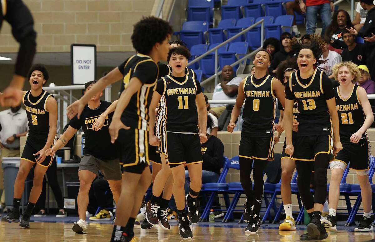 The Brennan bench reacts after a score against Taft during their 6A regional semifinal boys basketball game at Northside Sports Gym on Tuesday, Feb. 28, 2023.