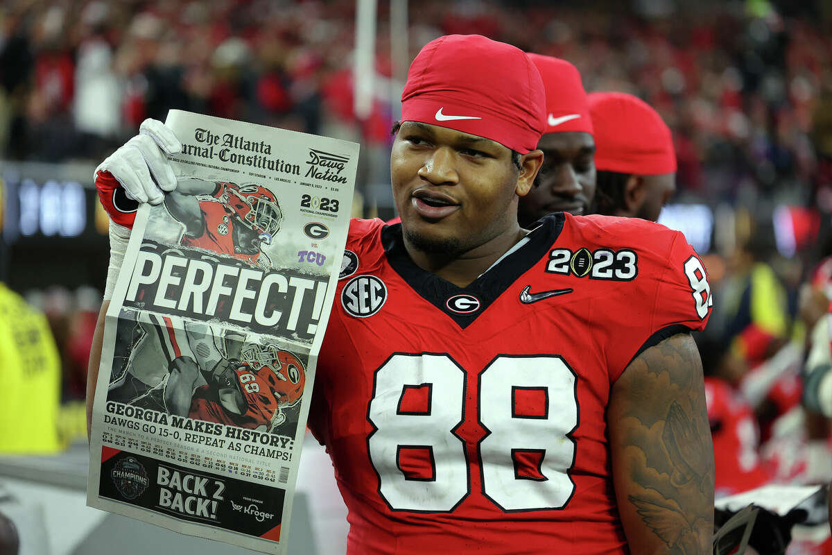 Jalen Carter #88 of the Georgia Bulldogs celebrates with a newspaper reading "Perfect!" after defeating the TCU Horned Frogs in the College Football Playoff National Championship game at SoFi Stadium on January 09, 2023 in Inglewood, California.