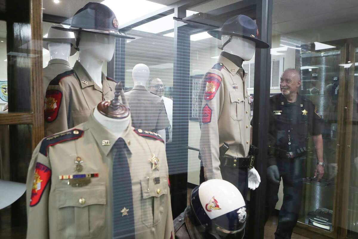 Montgomery County Sheriff’s Department Capt. Dan Norris looks over display uniforms while visiting the department’s newly opened museum honoring its 185-year history, Tuesday, March 7, 2023, in Conroe. The museum recently opened to the public.