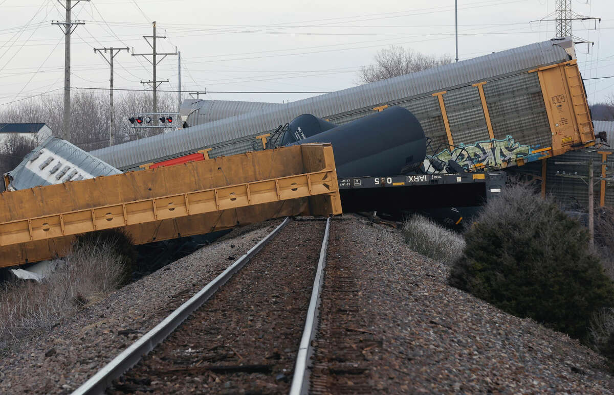 Multiple cars of a Norfolk Southern train lie toppled after derailing at a train crossing in Springfield, Ohio.