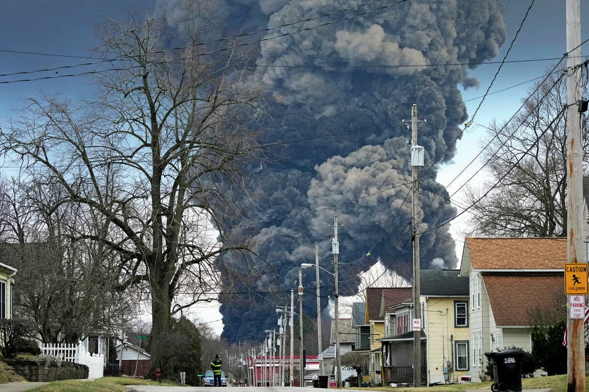 A plume of smoke rises over East Palestine, Ohio, as a result of the controlled detonation of a portion of a derailed Norfolk Southern train.