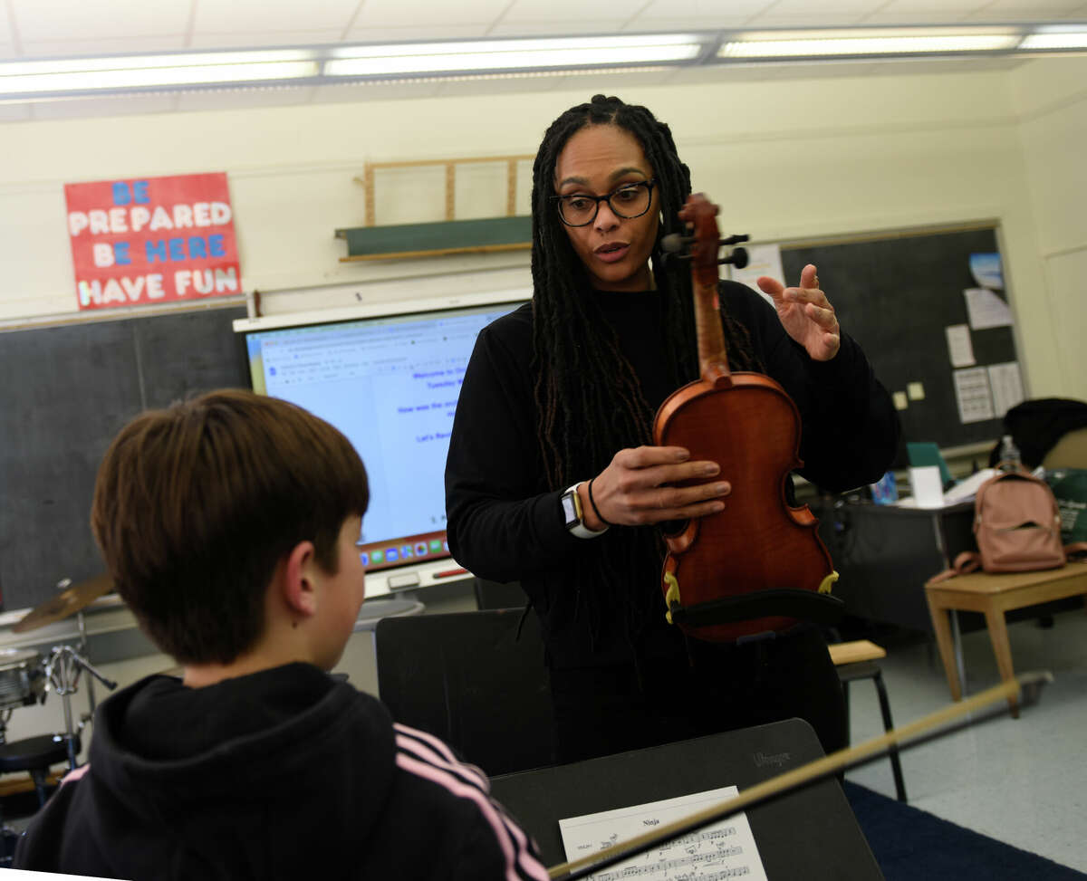 Orchestra director Lakshmi James teaches a fifth-grade violin class at Old Greenwich School in Old Greenwich, Conn. Tuesday, March 7, 2023. James played viola during two shows with Motown legend Smokey Robinson over the weekend in Atlantic City.