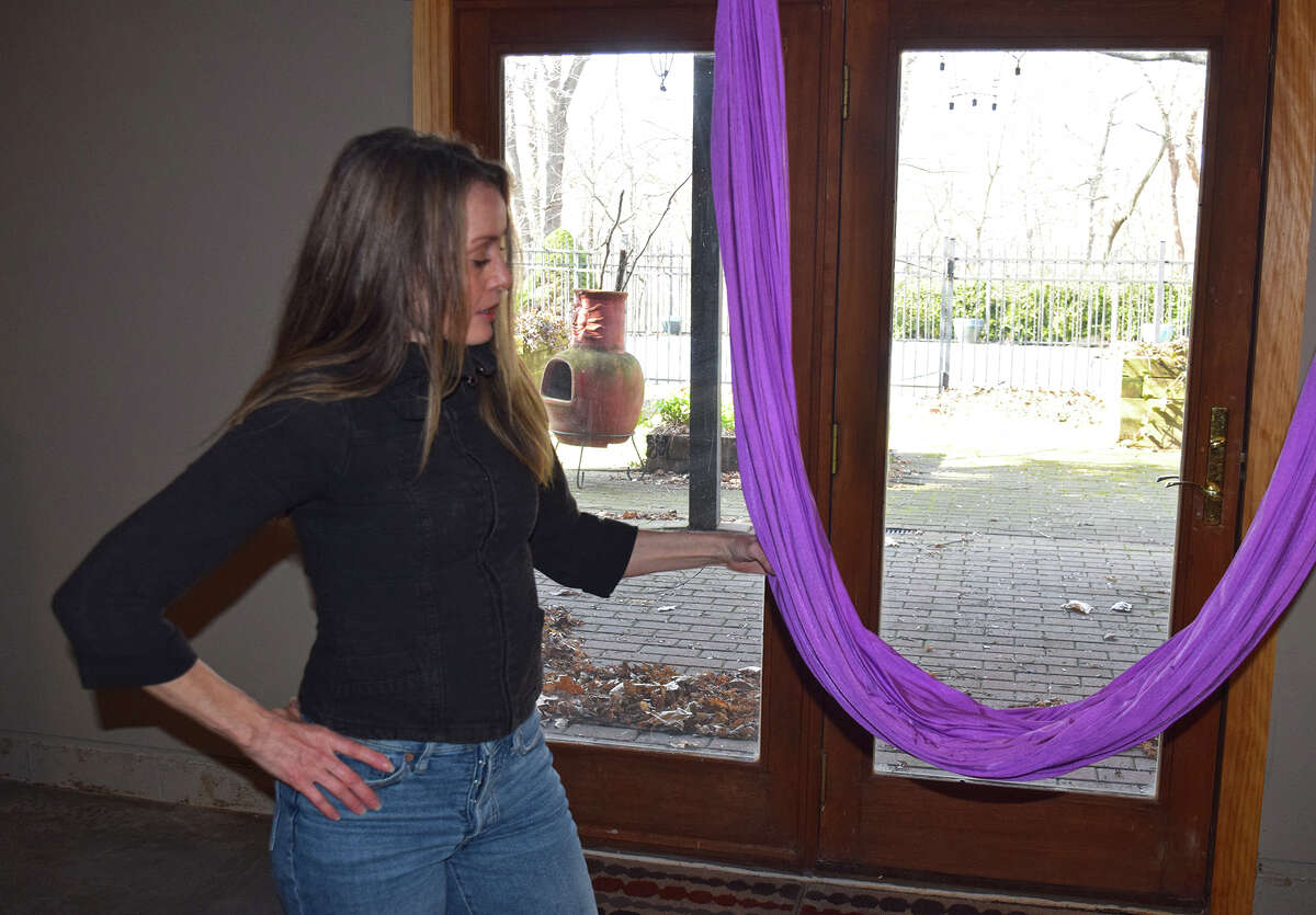 Holistic health practitioner Julia Leischner holds a hammock used for aerial yoga at Morningstar Holistic Wellness. Yoga is one of several naturopathic methods Leischner uses.