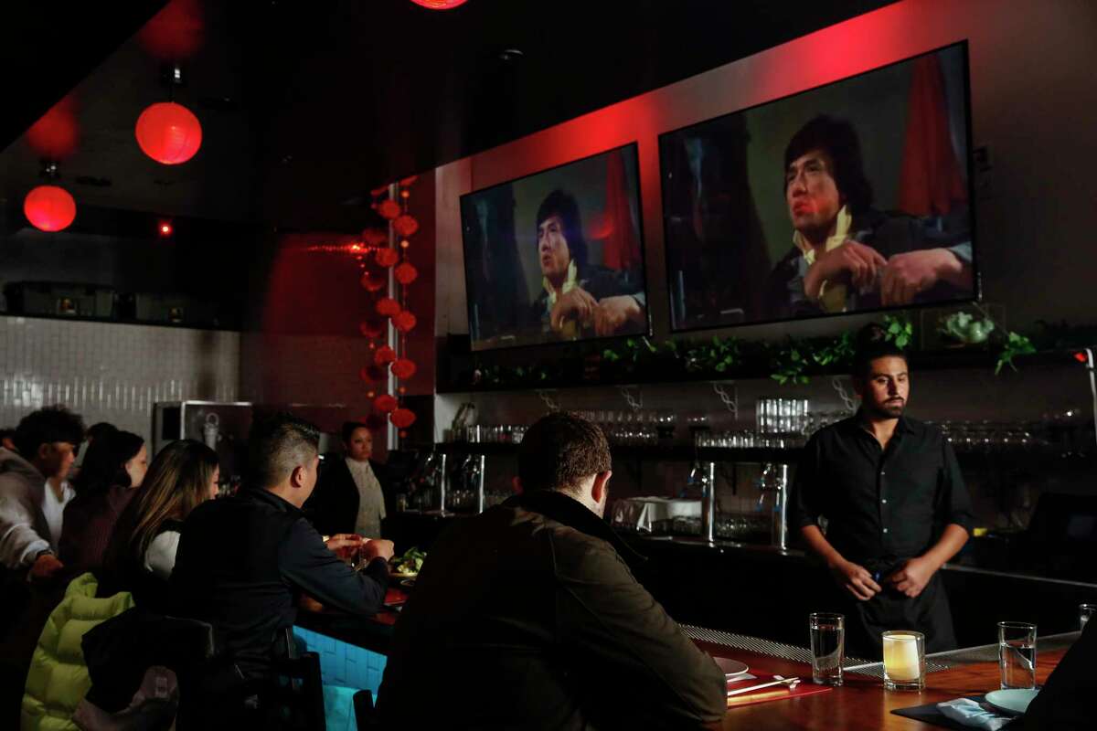 Diners who sit at the bar can watch old kung fu movies while they eat.