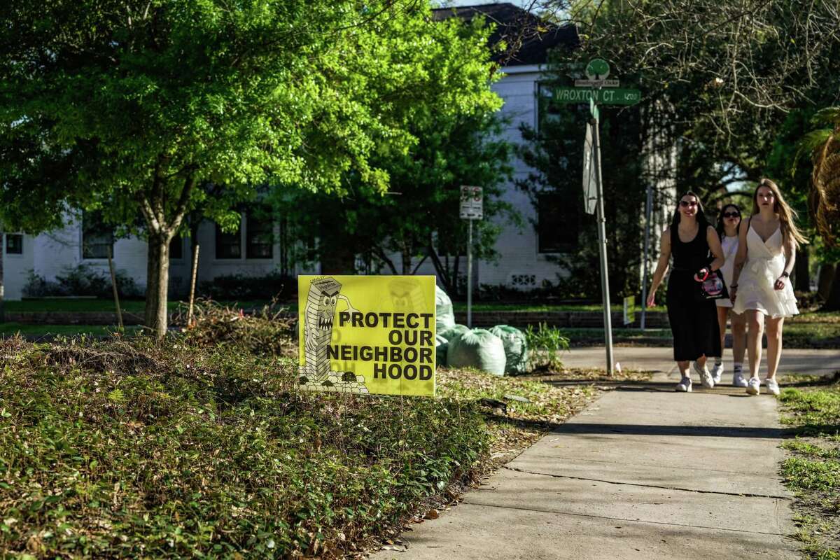 A home displays a sign against a development looking to turn an empty lot into a 20 story high rise in the neighborhood of Boulevard Oaks / Southampton near Rice University on Saturday, March 4, 2023 in Houston.