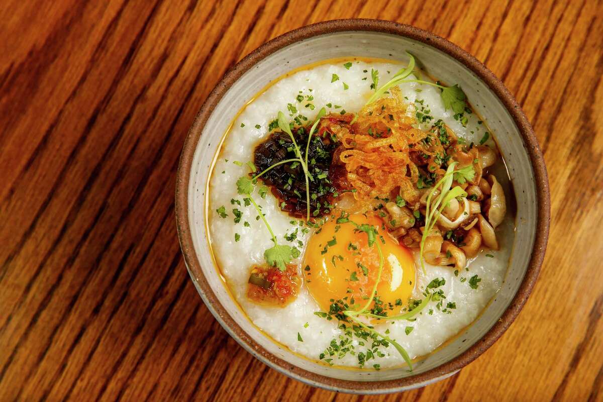 Congee is crowned with a velvety egg yolk at Piglet & Co. in San Francisco.