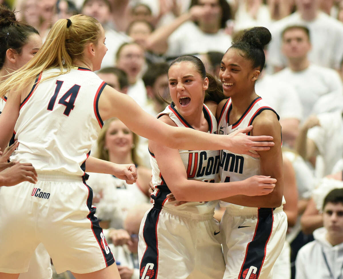 UConn's Dorka Juhasz, left, Nika Muhl, center, and Aubrey Griffin, right, celebrate after scoring in the NCAA women's basketball game between No. 5 UConn and No. 1 South Carolina at the XL Center in Hartford, Conn. Sunday, Feb. 5, 2023.