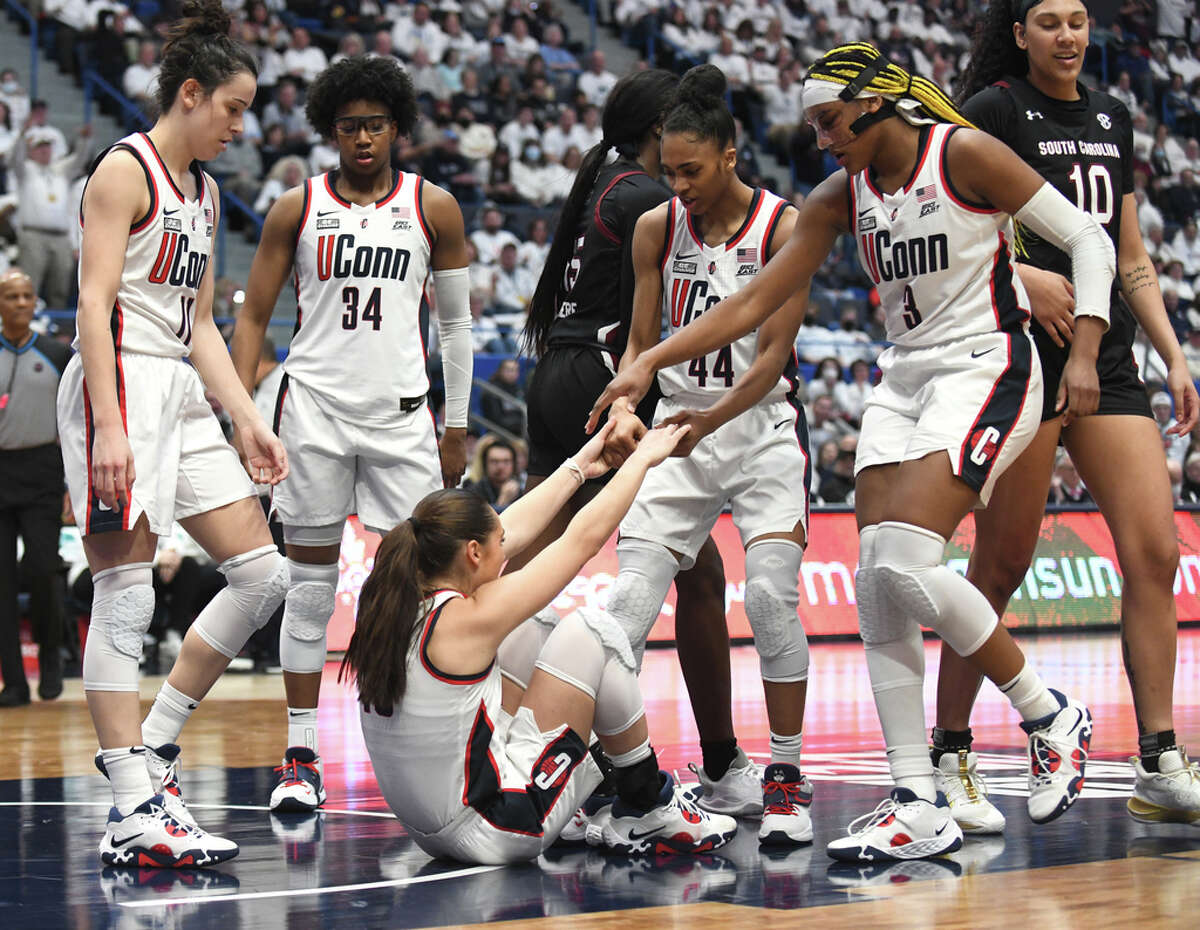 Teammates help up guard Nika Muhl after a foul in No. 1 South Carolina's 81-77 win over No. 5 UConn in the NCAA women's basketball game at the XL Center in Hartford, Conn. Sunday, Feb. 5, 2023.