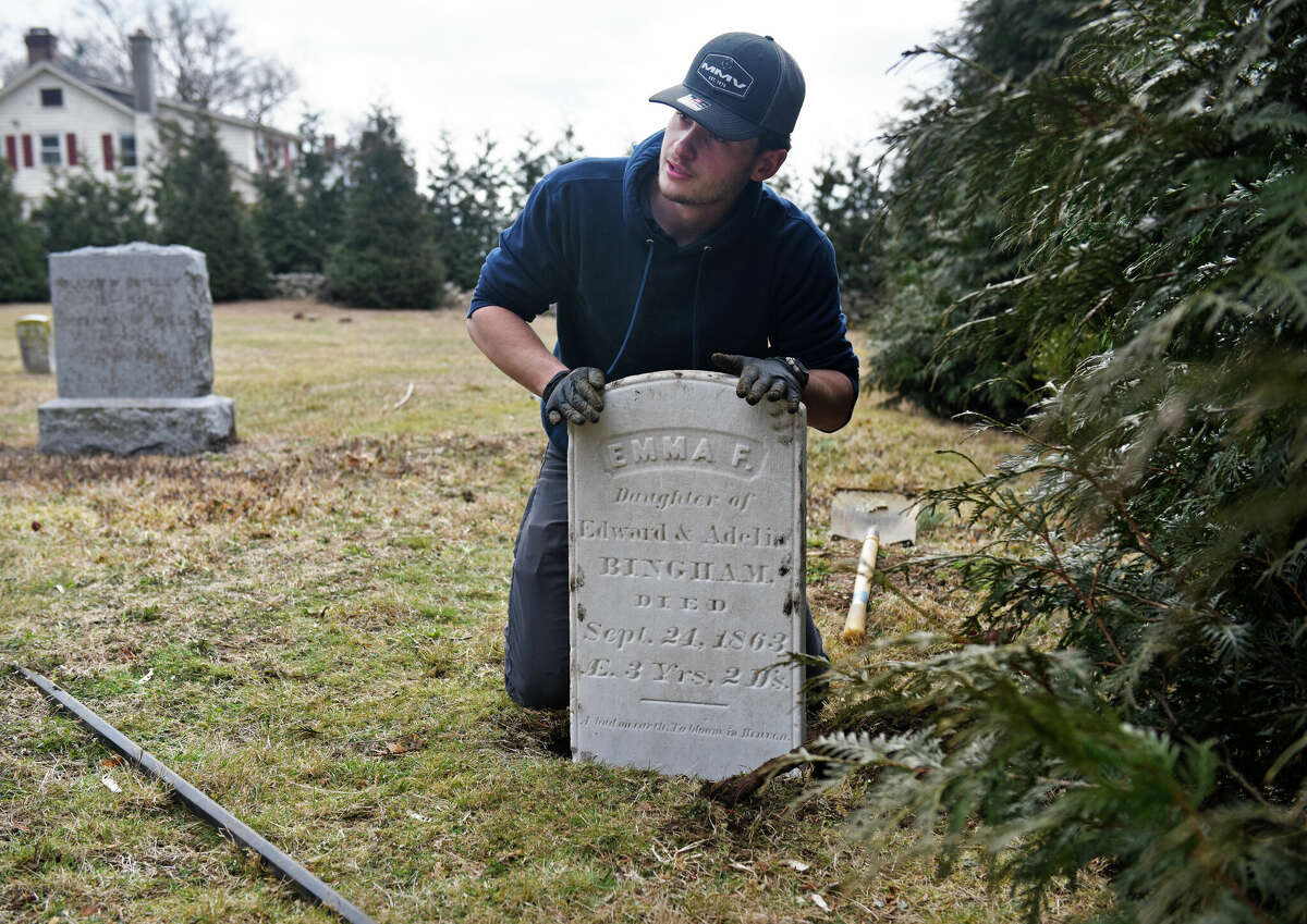 Victor Ives, of Wilbert Funeral Services, transports and installs the headstone of Emma F. Bingham from Milford to her resting place at Noroton River Cemetery in Darien, Conn. Tuesday, March 7, 2023. Bingham died on Sept. 24, 1863 at the age of three and her headstone was mysteriously discovered in Milford Cemetery's storage despite her being buried 30 miles away in the Noroton River Cemetery in Darien. The stone was cleaned and returned to its original location in Darien on Tuesday.