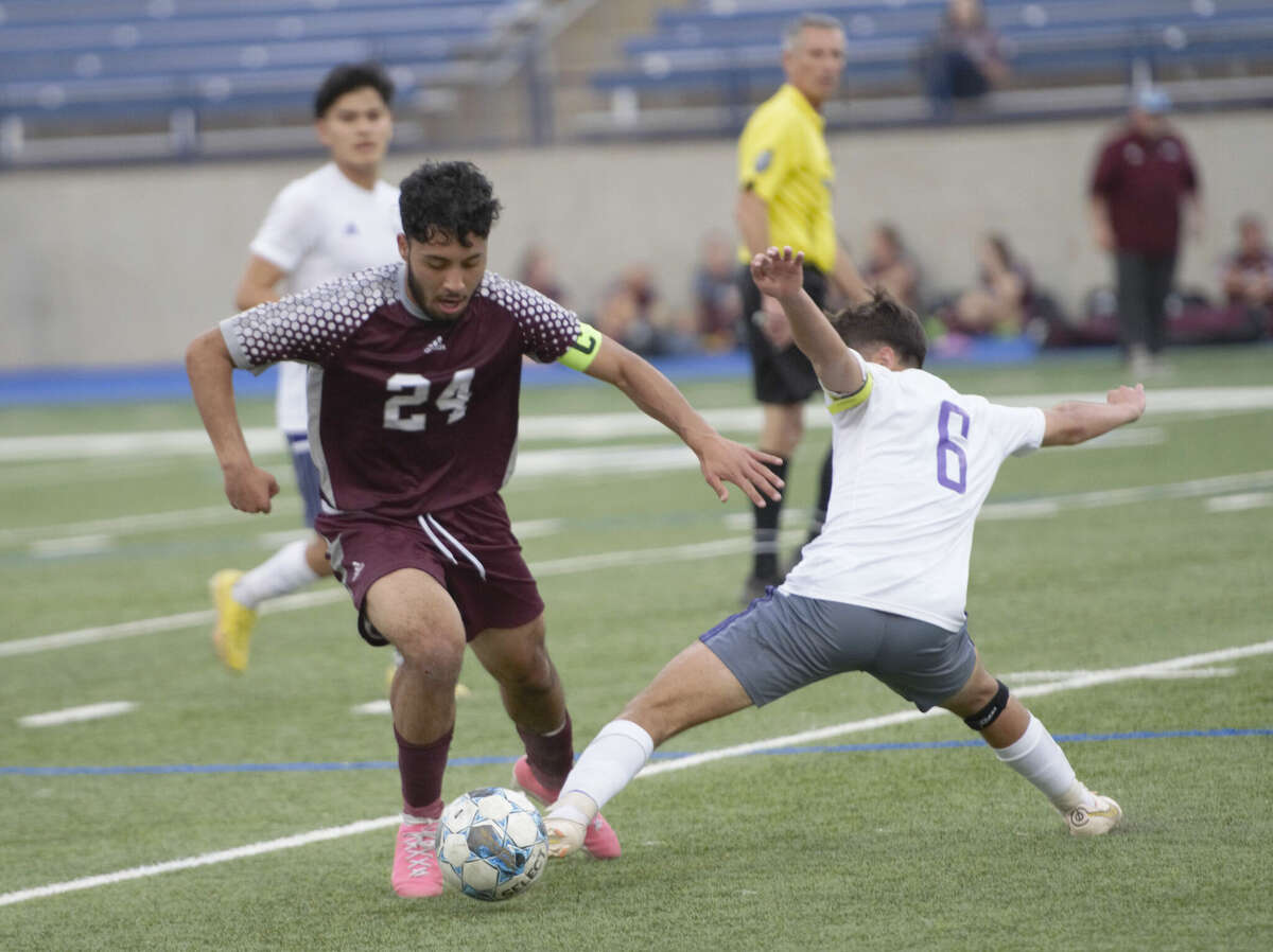 Midland High's Jerron Garcia (6) tries to dislodge the ball from Legacy's Alan Martinez during a District 2-6A boys soccer match, March 7 at Astound Broadband Stadium. 