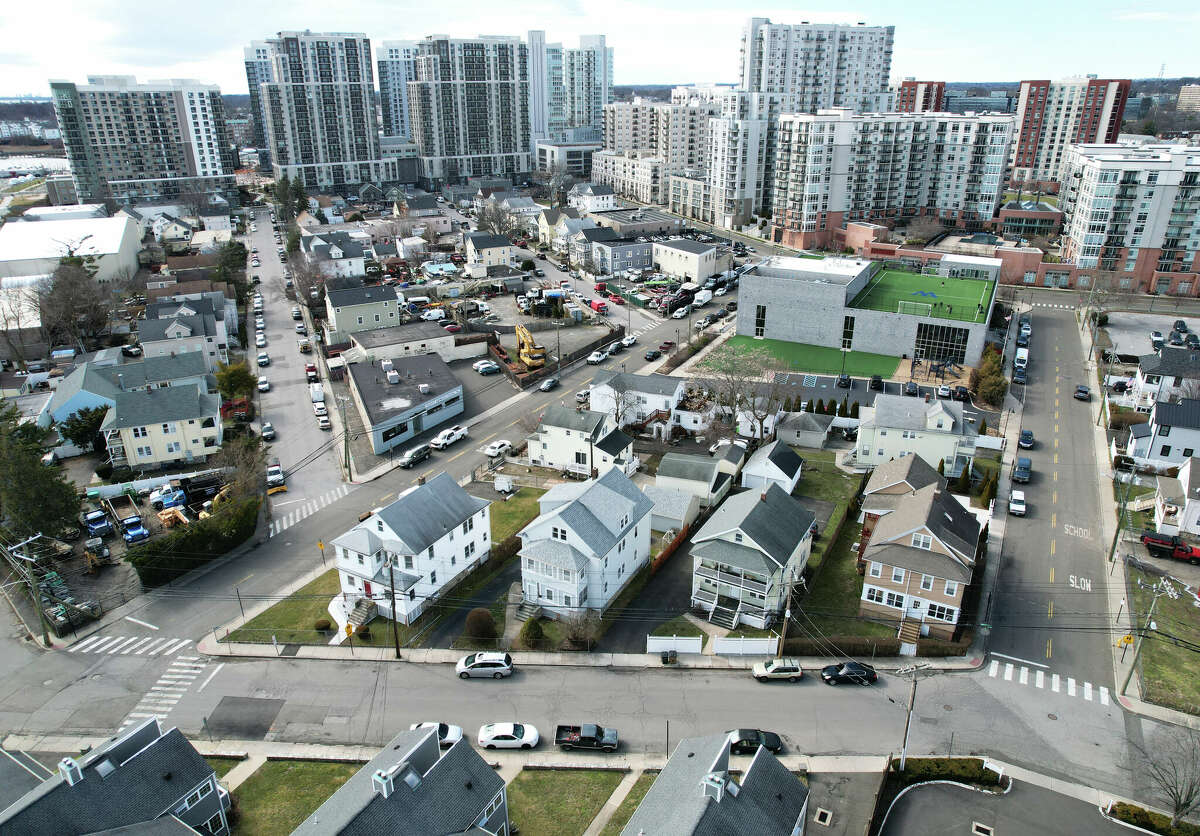 A residential street overlooks new high rise apartments in the South End of Stamford, Conn. Monday, March 6, 2023.