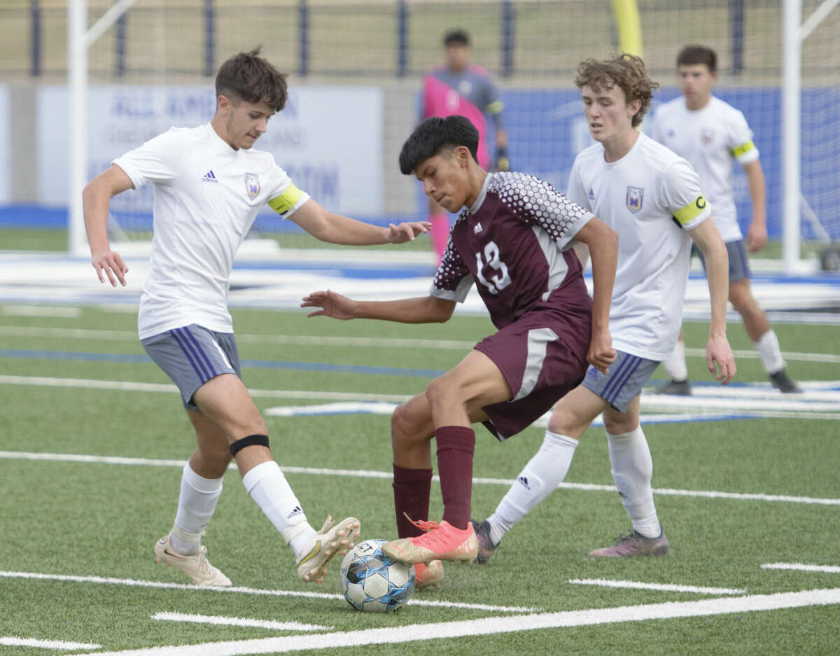 Legacy's Enzo Pino Vilca tries to keep the ball away from Midland High's Jerron Garcia during a District 2-6A boys soccer match, March 7 at Astound Broadband Stadium. 