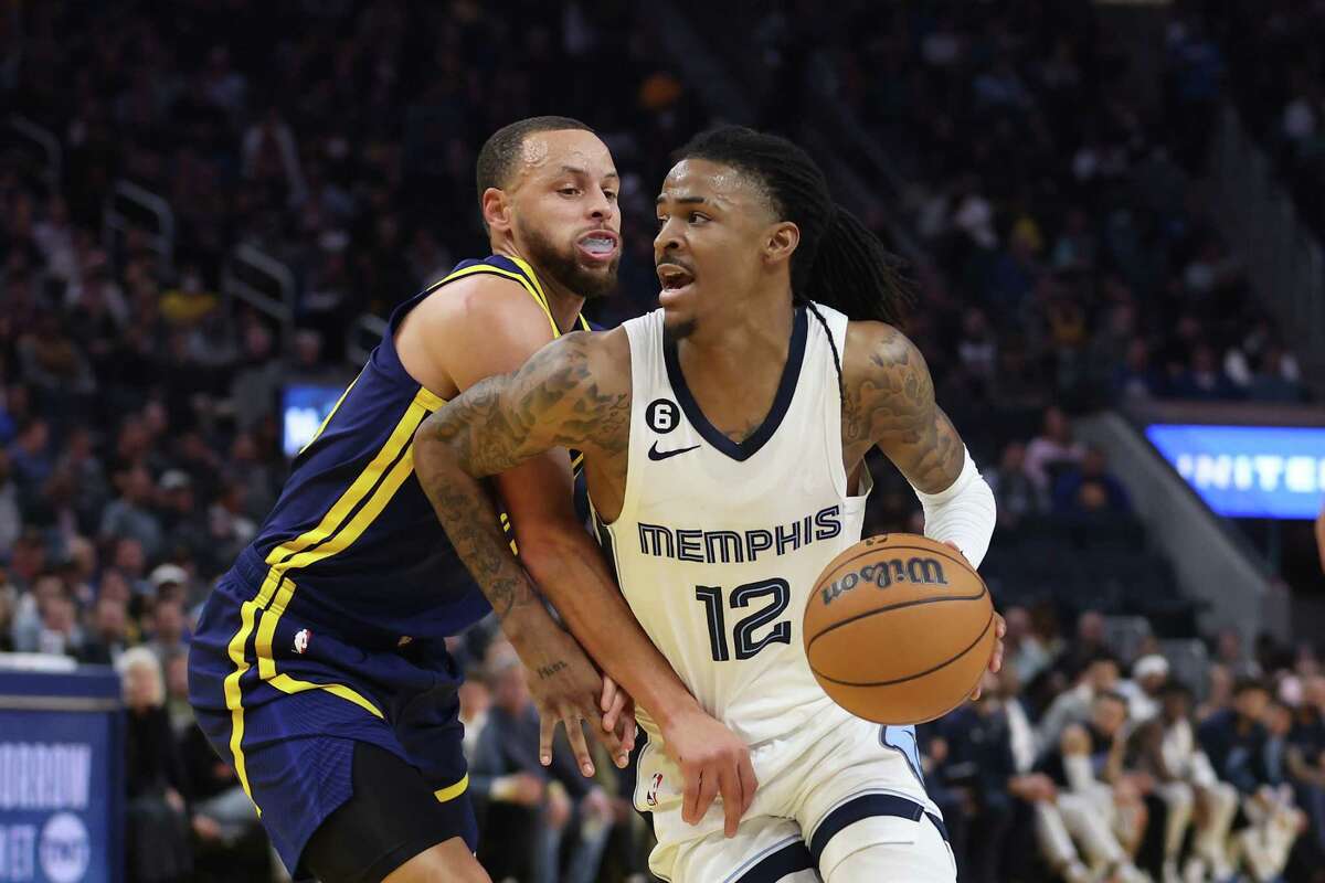 Memphis star Ja Morant drives against Warriors guard Stephen Curry on Jan. 25. Morant could learn a lot about how to conduct himself from Curry.