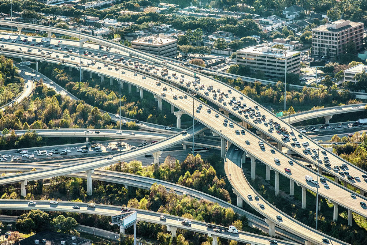 A grouping of freeways layered and curving in the downtown Houston, Texas area shot from from an altitude of about 1500 feet.