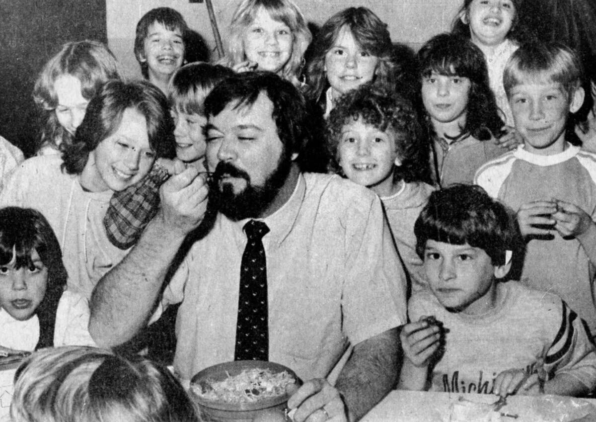 It was Taco Day at South Elementary this past week with students preparing their own meal at a taco bar. Teacher Mike Brougham scoops a taco dish as students crowd around him. The photo was published in the News Advocate on March 9, 1983.
