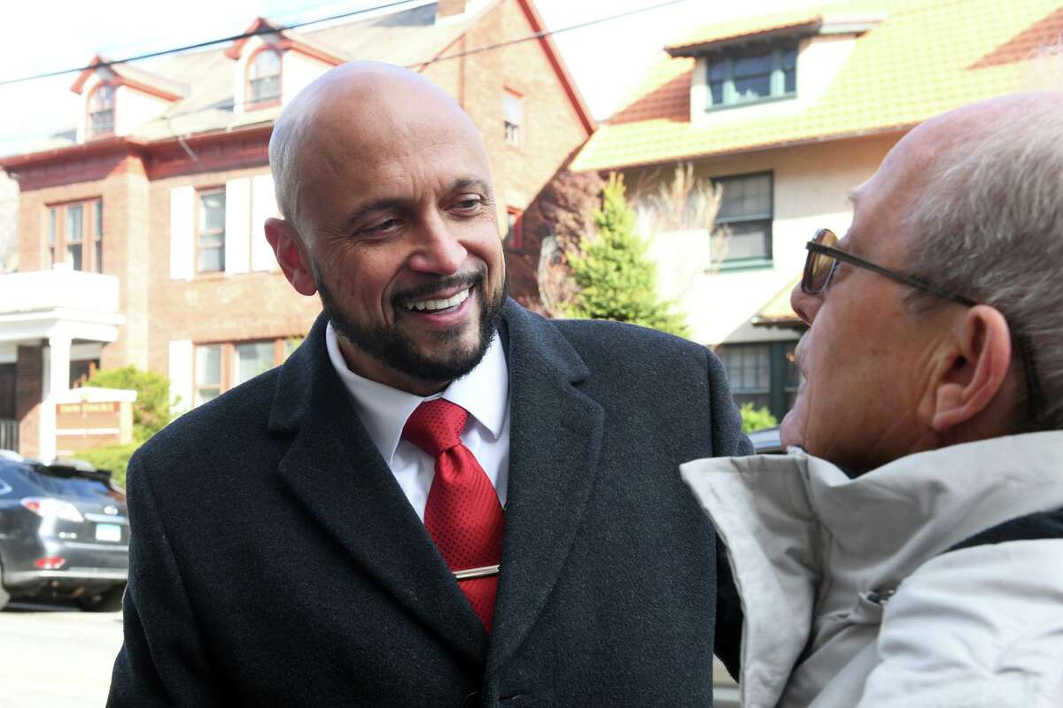 John Gomes speaks to a supporter as he arrives to announce his candidacy for mayor at Bridgeport City Hall, in Bridgeport, Conn. Dec. 1, 2022.