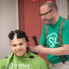 Volunteer cutter Jerry Ventrella of Branchville Hair Design in Wilton goes to work on Jackson Duncan, 17, of Wilton. (Photo by Jarret Liotta) on Tuesday, March 8, at Wilton High School. for the St. Baldrick's Foundation event done in cooperation with the student-organized group Conquer Kids' Cancer.