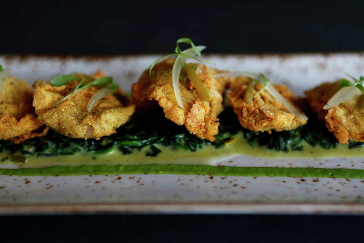 Fried oysters Oysters sit on creamed spinach with pickled jalapeños and red onions are on the snack menu at State Fare on Monday, Dec. 12, 2016, in Houston. (Annie Mulligan / Freelance)