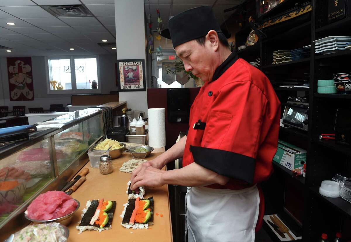 Jerry San makes a tuna roll for a customer at the new location of his restaurant, Jerry-San's Sushi Bar, on Jefferson Road in Branford.
