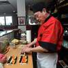 Jerry San makes a tuna roll for a customer at the new location of his restaurant, Jerry-San's Sushi Bar, on Jefferson Road in Branford on March 7, 2023.