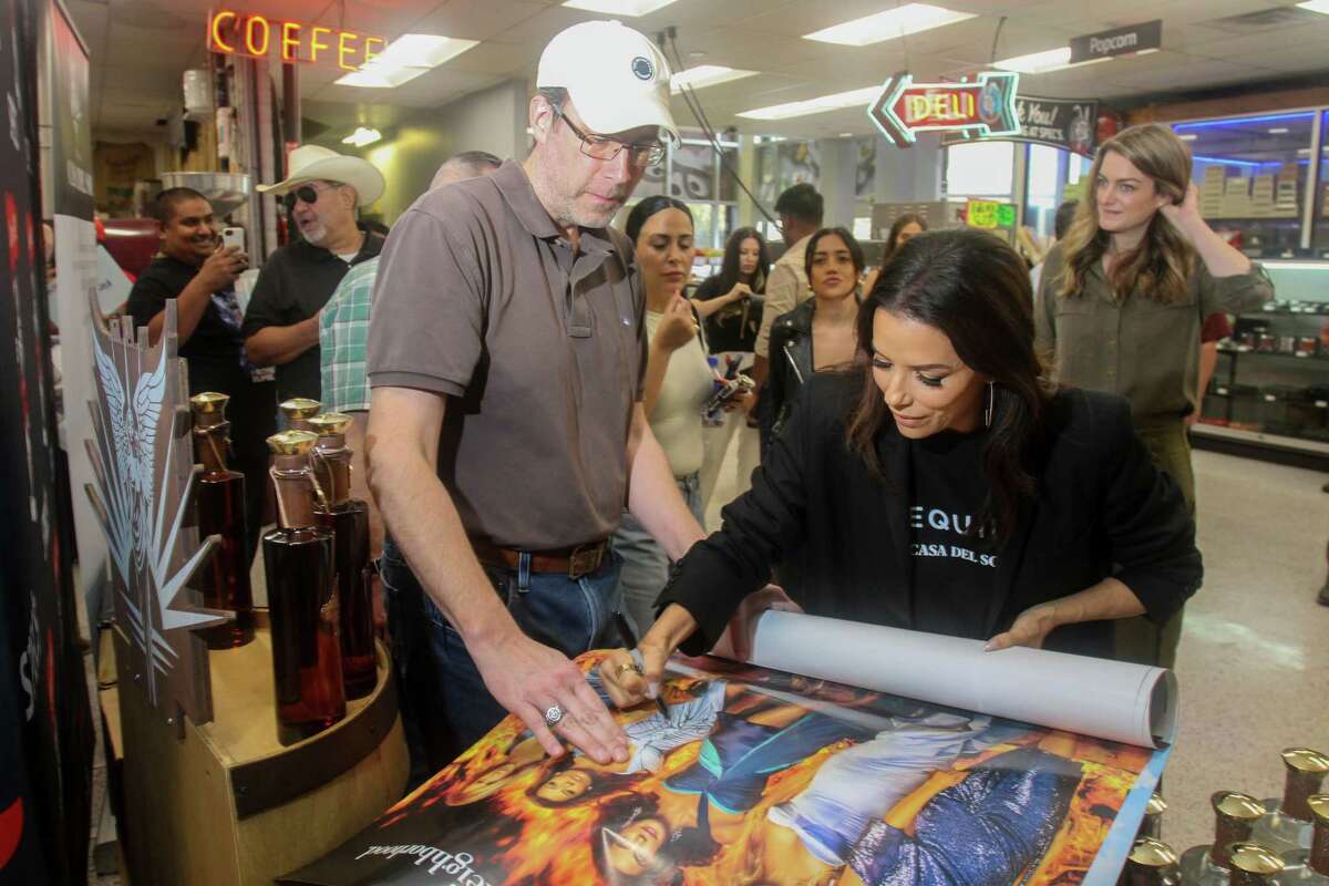 Branch Sheppard with actress Eva Longoria, who is signing his posters. Longoria was at Spec's in Houston to talk about Casa Del Sol, her tequila brand, on March 8, 2023.