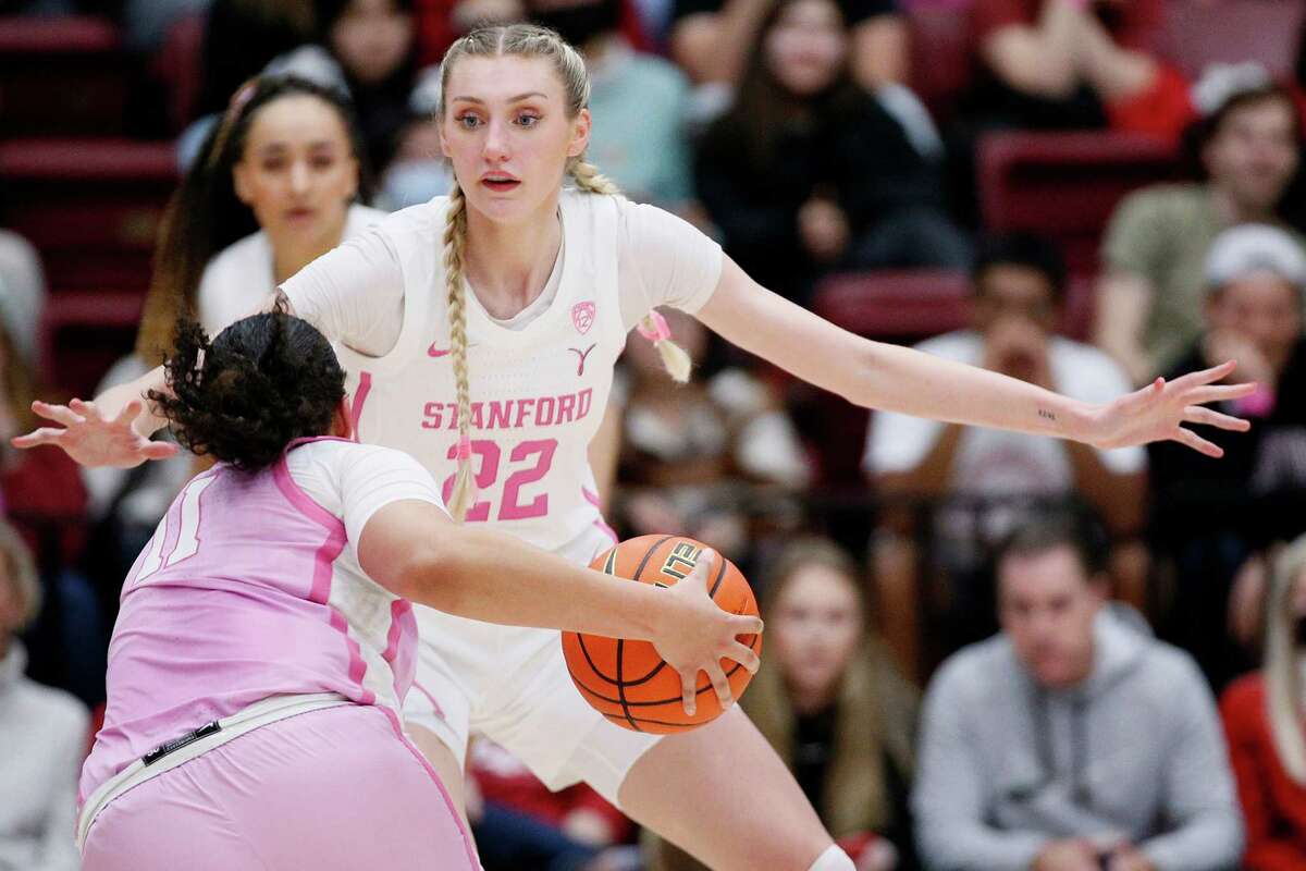 Stanford Cardinal forward Cameron Brink (22) defends USC Trojans guard Destiny Littleton (11) in the second half of an NCAA women’s basketball game at Maples Pavilion in Stanford, Calif., Friday, Feb. 17, 2023. The Cardinal won 50-47.