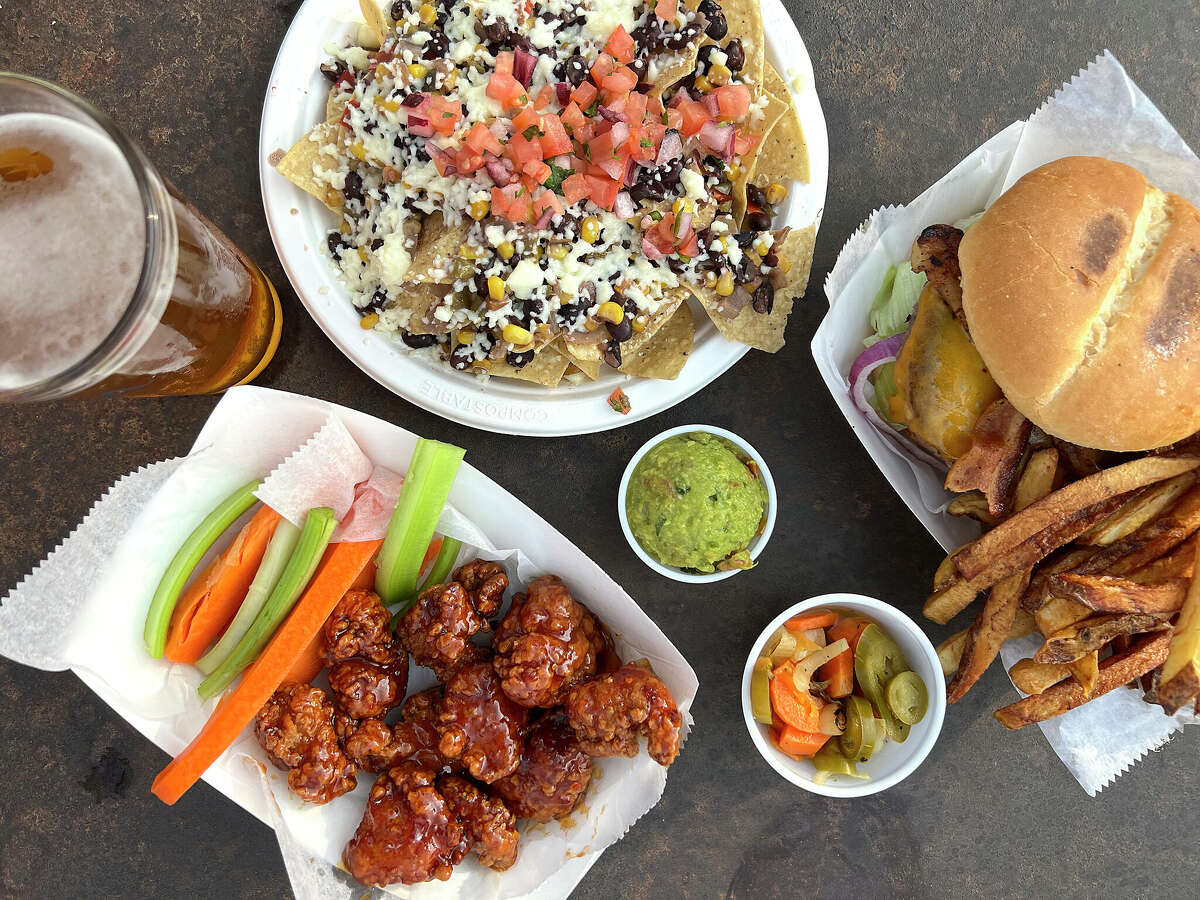 The Friendly Spot ice house on South Alamo Street in San Antonio does steady business with beer, cocktails and food, including Mexican street corn nachos, a bacon cheeseburger and boneless chicken wings. 