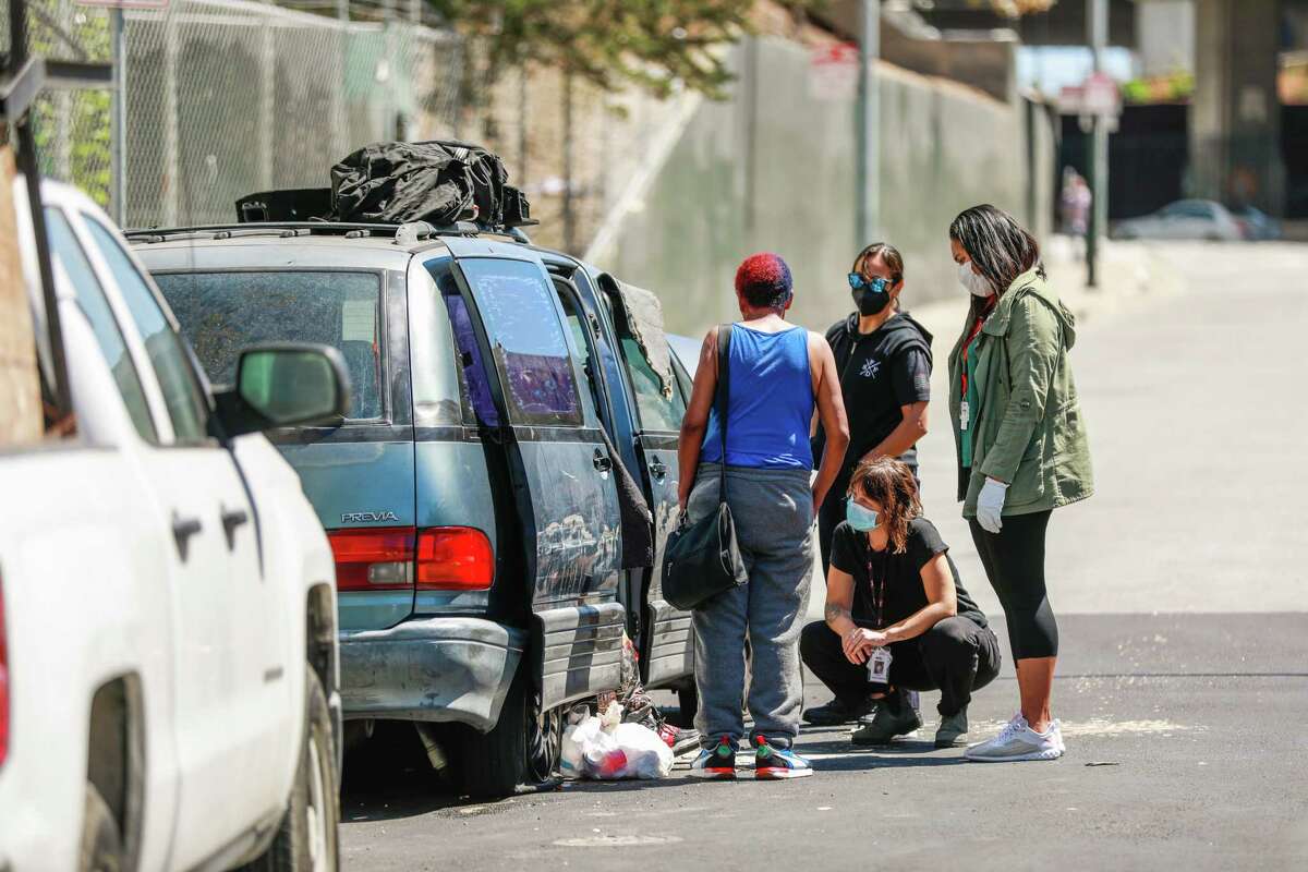 The Street Crisis Response team attempt to get a woman a place to sleep instead of her broken down car in San Francisco, California on Thursday, Aug. 25, 2022.