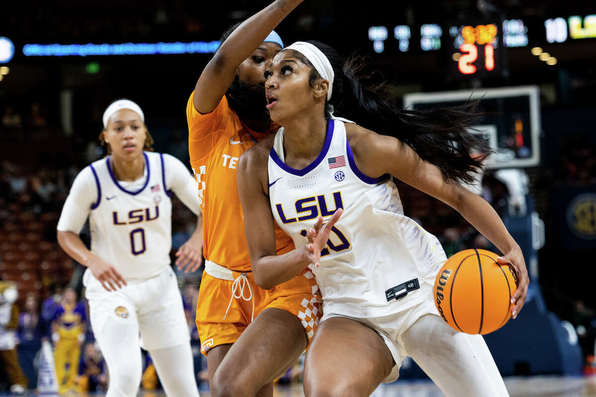 LSU's Angel Reese, right, drives to the basket against Tennessee's Rickea Jackson in the first half of an NCAA college basketball game during the Southeastern Conference women's tournament in Greenville, S.C., Saturday, March 4, 2023. (AP Photo/Mic Smith)