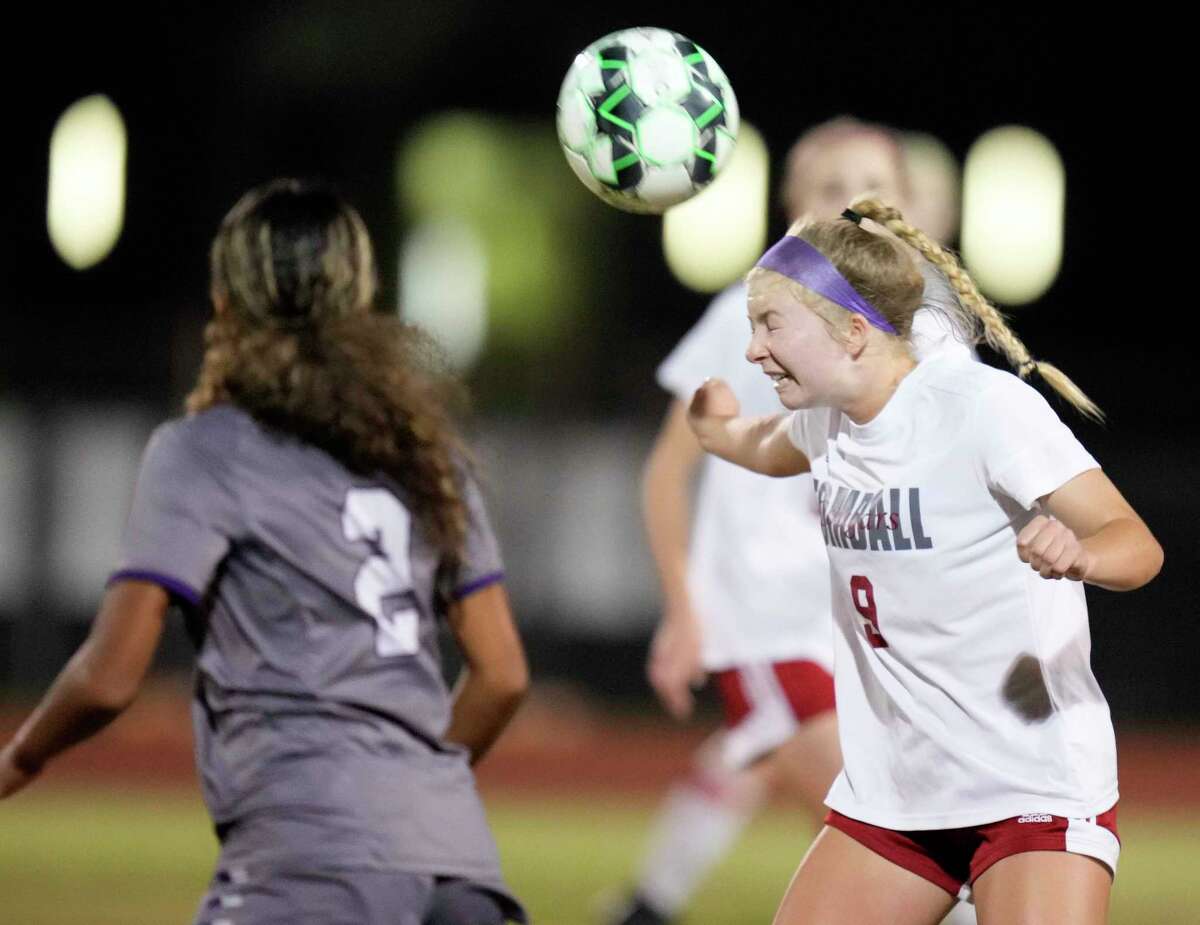 Tomball defender Mara Polanek, right, heads the ball during the first half of a high school soccer game against Klein Cain, Wednesday, March 8, 2023, in Houston.