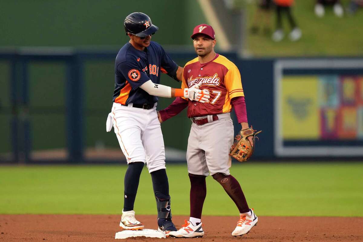 The Astros' Mauricio Dubon greets teammate Jose Altuve, playing for Team Venezuela, during Wednesday's exhibition game.