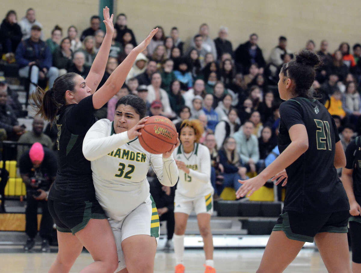 Gianna Robert of Hamden works hard to get a shot off with Alyssa Rossignol of Enfield guarding her tightly. Sdyney Marshall (21) of Enfield looks on during the CIAC Class LL quarterfinals Wednesday.