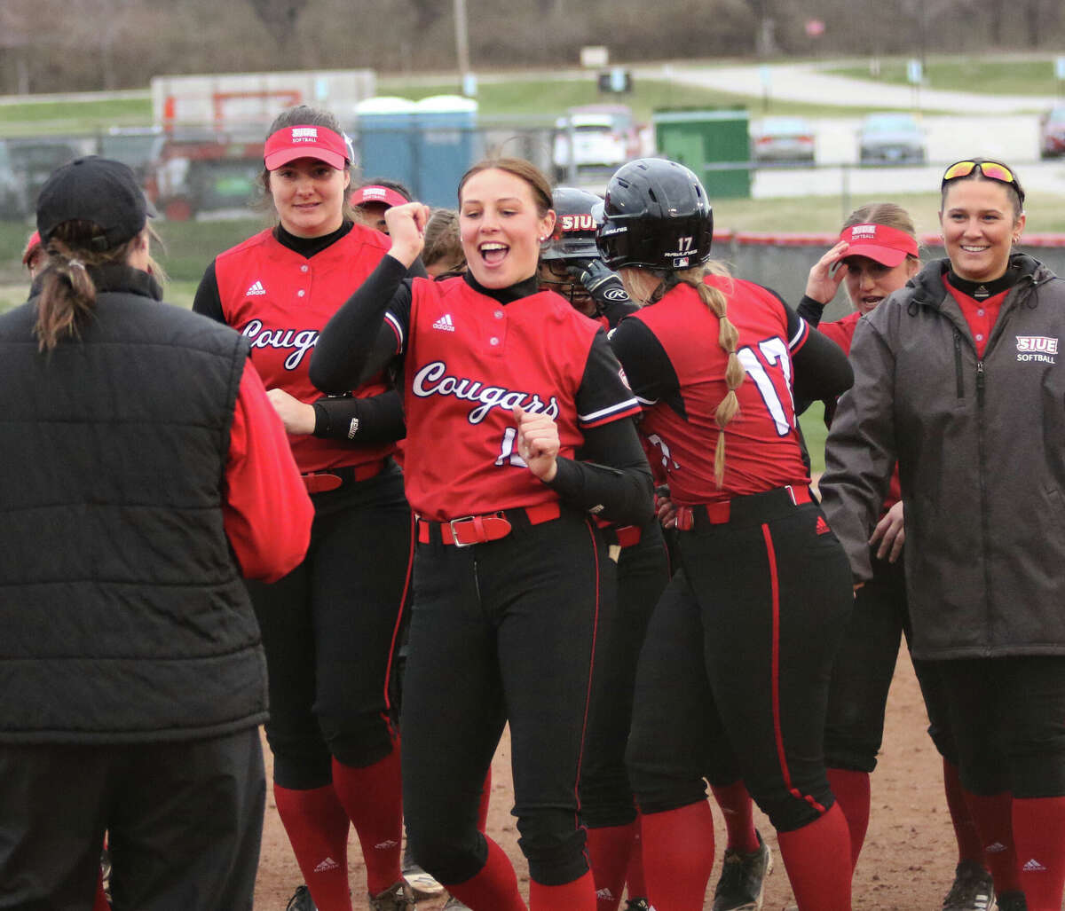 SIUE winning pitcher Sydney Baalman (middle) busts out a little dance move while the Cougars celebrate a walk-off win over Saint Louis on Wednesday afternoon at Cougar Field in Edwardsville.
