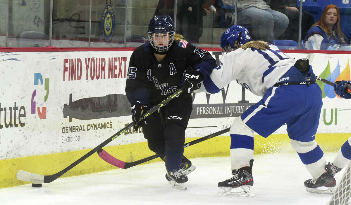 Southington/Avon's Bella Bonfiglio (15) controls the puck while Darien's Gretchen Edwards defends during the CHSGHA girls ice hockey final at Quinnipiac's M&T Bank Arena in Hamden on Wednesday, March 8, 2023.