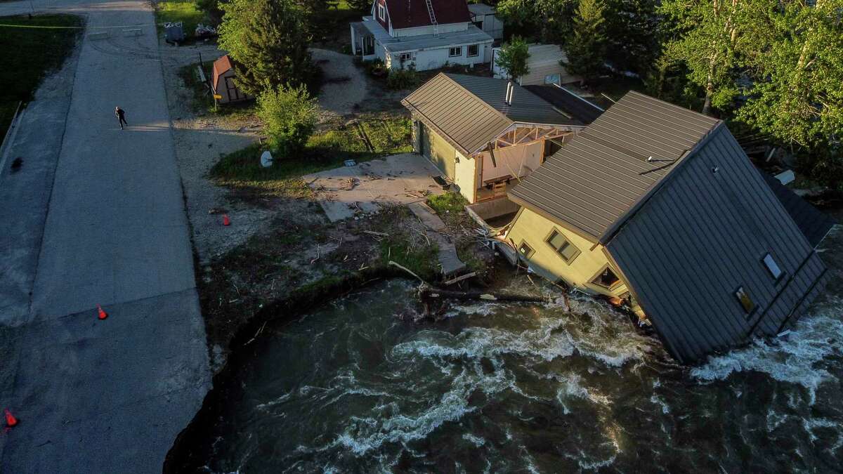 FILE - A house sits in Rock Creek after floodwaters washed away a road and a bridge in Red Lodge, Mont., Wednesday, June 15, 2022. After three nasty years, the La Nina weather phenomenon is gone, the National Oceanic and Atmospheric Administration said Thursday, March 9, 2023.
