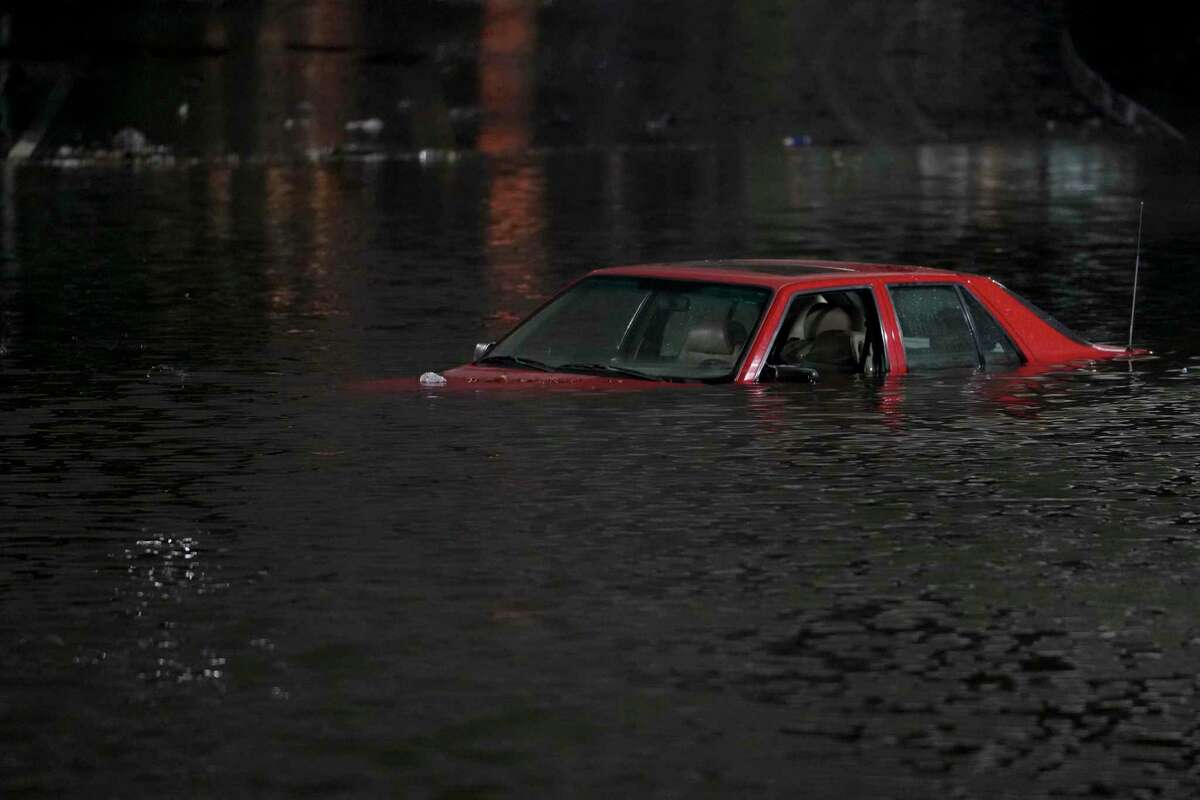 FILE - An empty vehicle is surrounded by floodwaters on a road in Oakland, Calif., Jan. 4, 2023. After three nasty years, the La Nina weather phenomenon is gone, the National Oceanic and Atmospheric Administration said Thursday, March 9.