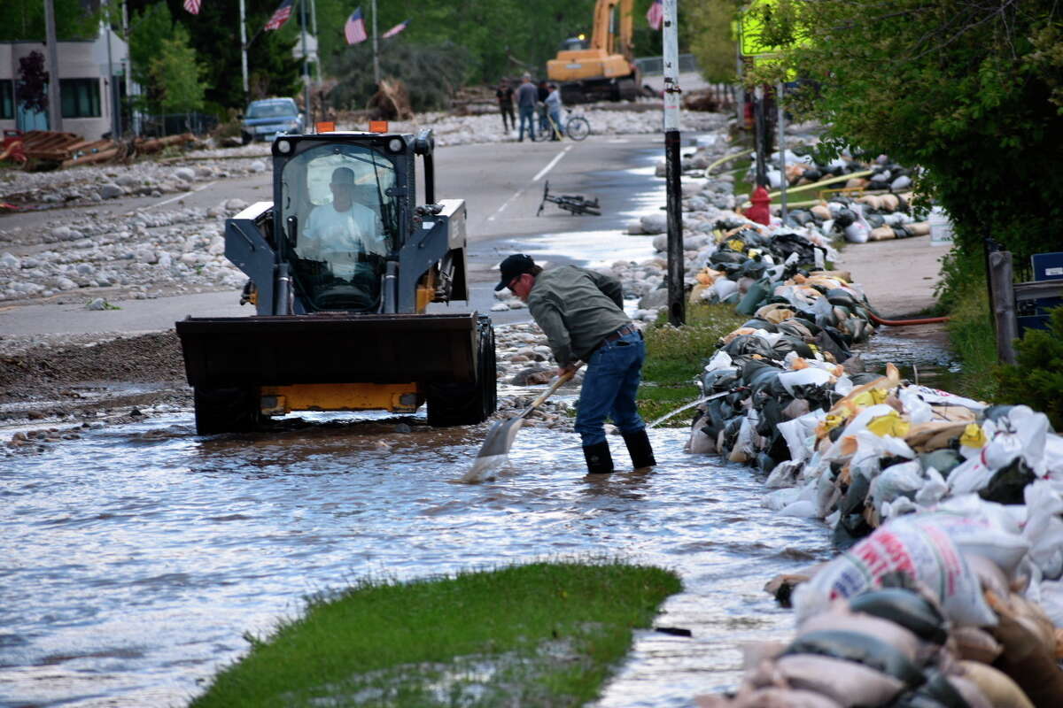FILE - Residents of Red Lodge, Montana, are seen clearing mud, water and debris from the small city's main street on Tuesday, June 14, 2022, after flood waters courses through a residential area with hundreds of homes. After three nasty years, the La Nina weather phenomenon is gone, the National Oceanic and Atmospheric Administration said Thursday, March 9, 2023.