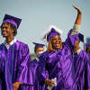 Shantinique Williams waves to the crowd as the processes onto the field for the commencement ceremony for Wheatley High School on Saturday, June 12, 2021, at Barnett Stadium in Houston.
