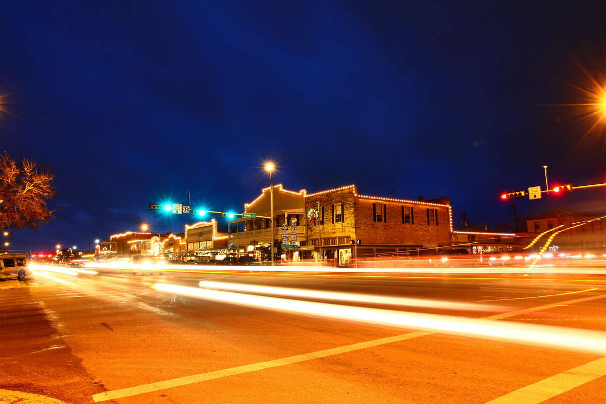 Beautiful city nightscape of road and land transportation against lighting in Fredericksburg, Texas.