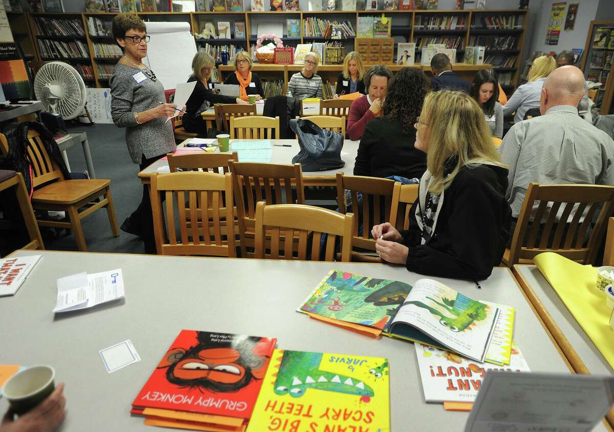 Volunteer readers gather in the library of Bryant School in Bridgeport before heading off to classrooms for the 33rd Annual Read Aloud Day in Bridgeport in 2018.