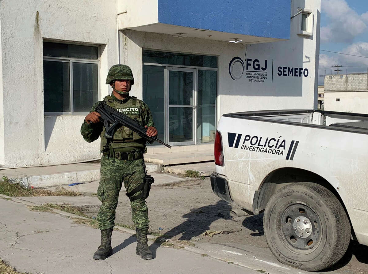 A Mexican army soldier guards the Tamaulipas State Prosecutor´s headquarters in Matamoros, Mexico, Wednesday, March 8, 2023. A road trip to Mexico for cosmetic surgery veered violently off course when four Americans were caught in a drug cartel shootout, leaving two dead and two held captive for days in a remote region of the Gulf coast before they were rescued from a wood shack, officials said Tuesday.