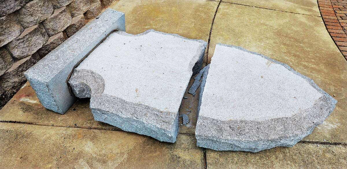 The broken marble stone engraved with the Native American legend of the Piasa Bird lays face down, broken into two pieces, Thursday morning in Piasa Park. 