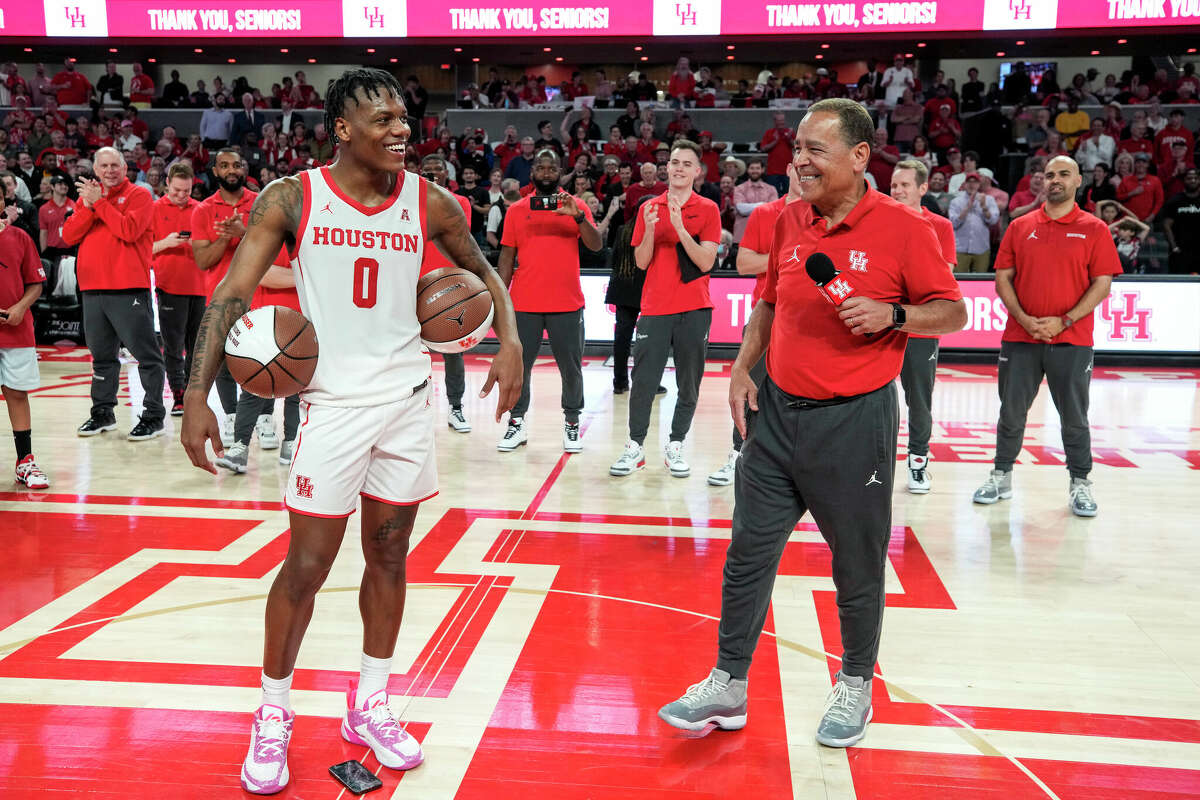 Houston guard Marcus Sasser (0) is presented with a pair of commemorative game balls by head coach Kelvin Sampson after beating Wichita State 83-66 in an NCAA college basketball game Thursday, March 2, 2023, in Houston.