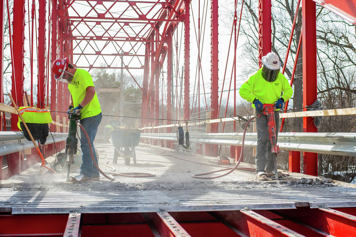 Ryan Coltson (right) and Matt Rezmer, of Fisher Construction, jackhammer concrete for a repair project on March 9, 2023 at the Currie Parkway Bridge in Midland.