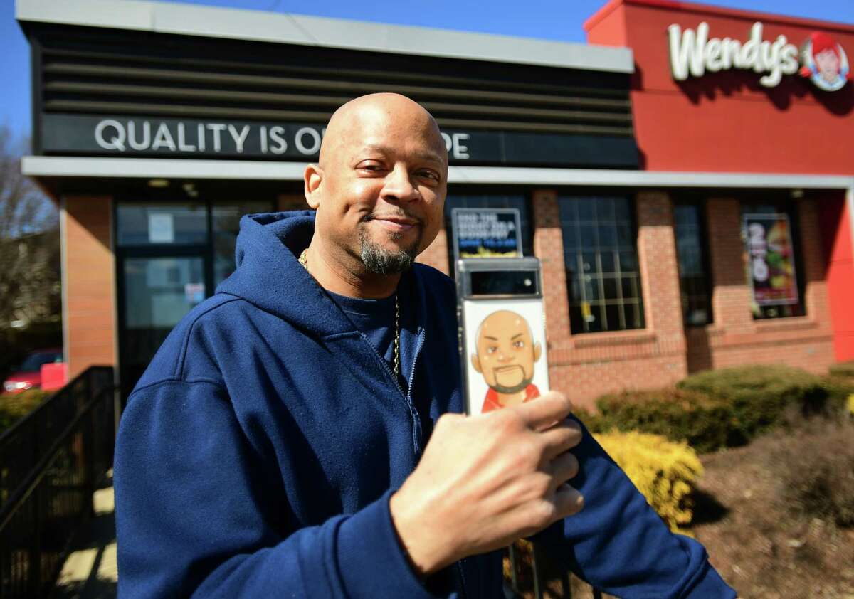 Bridgeport YouTuber Claude Patterson records his latest food review video outside the Wendy's restaurant on Fairfield Avenue in Bridgeport, Conn. on Thursday, March 09, 2023.