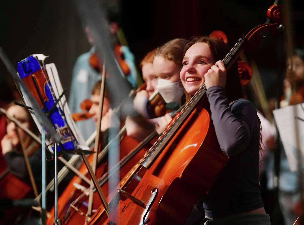 Mark Wood, of the Trans-Siberian Orchestra, works with Milford Public Schools string players during a two day Electrify Your Symphony workshop at the Parsons Government Center in Milford, Conn., on Thursday, March 09, 2023.
